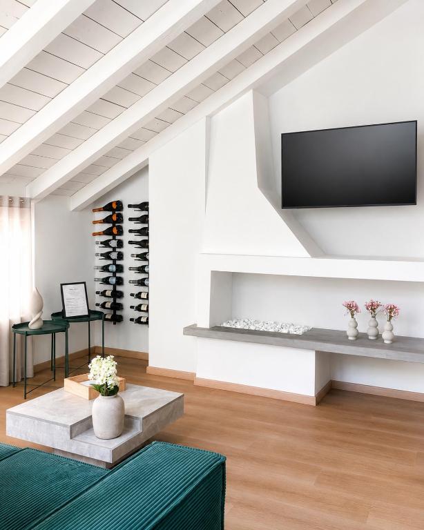 ein Wohnzimmer mit Fernseher und Weinkeller in der Unterkunft Sebì Suite in Iseo
