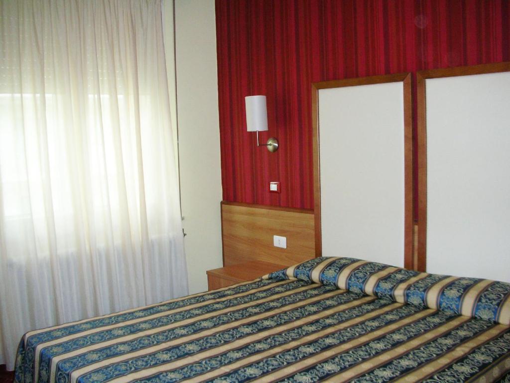 Postel nebo postele na pokoji v ubytování Hotel Promenade Universale