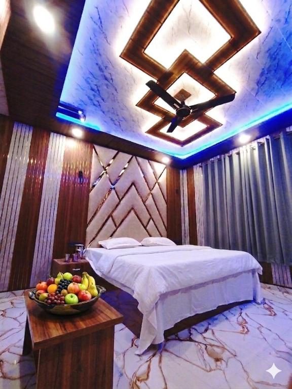 a bedroom with a bed and a bowl of fruit on a table at HOTEL FABULOUS KASHMIR, Dal lake in Srinagar