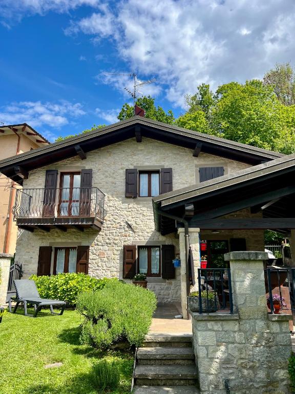 a stone house with a porch and a balcony at Cà Toni in Pavullo nel Frignano