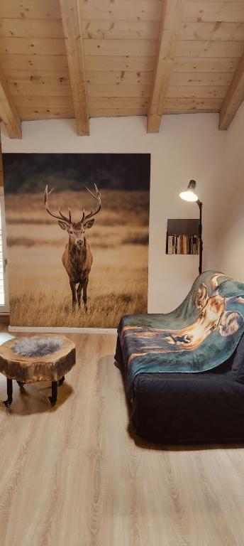 a room with a large painting of a bull in a field at Il borghetto di Lele & Schina in Arvier