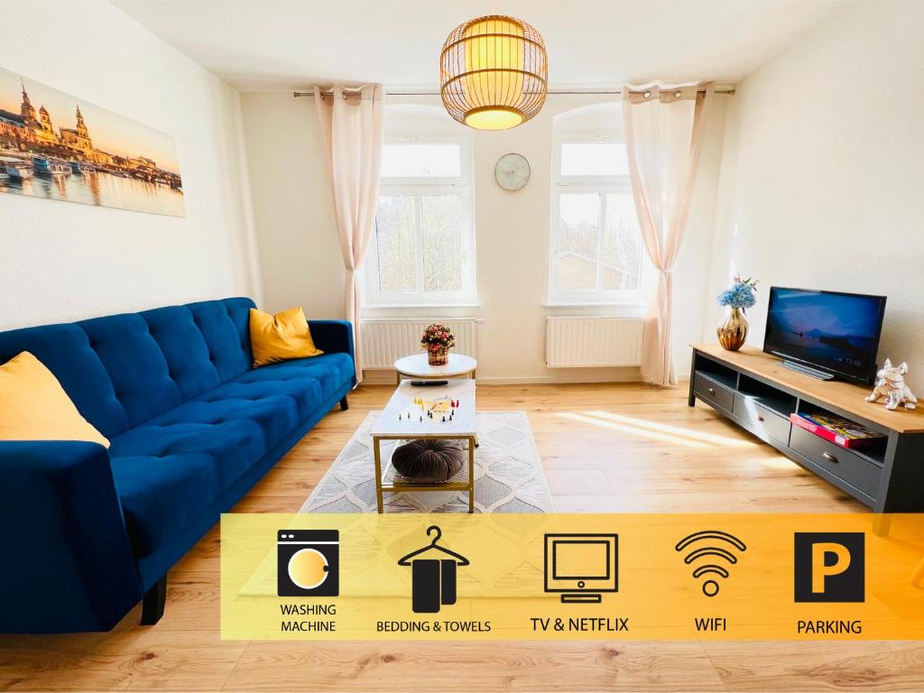 a living room with a blue couch and a tv at Twenty Five Apartment bei Dresden - free Parking, Netflix & Coffee Machine in Heidenau