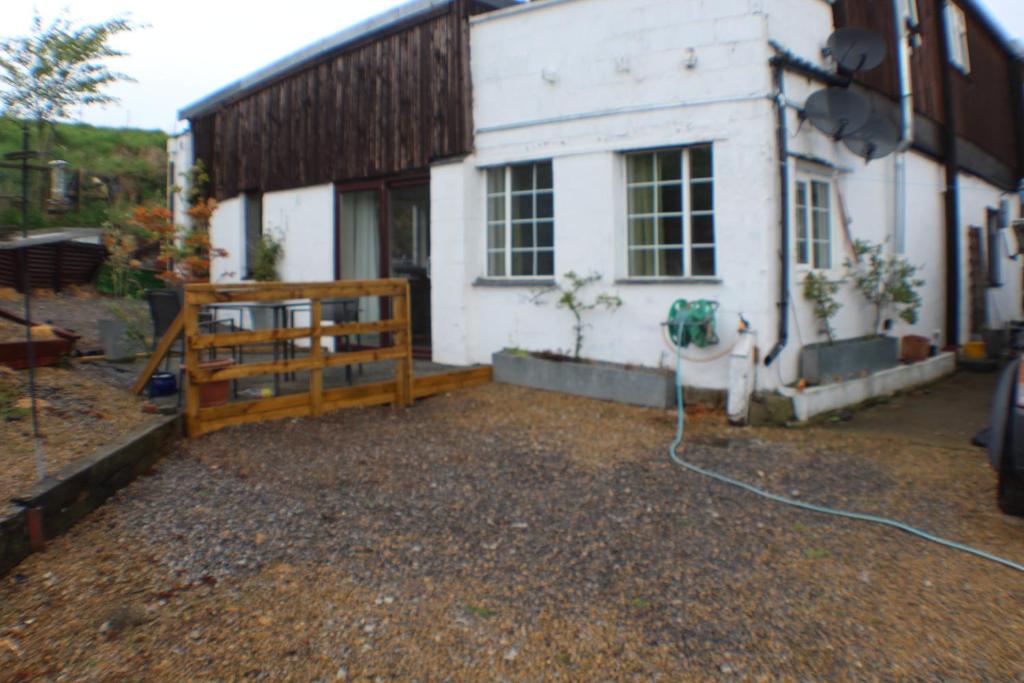 a house with a bench in front of it at Grove Stables in Kirk Leavington