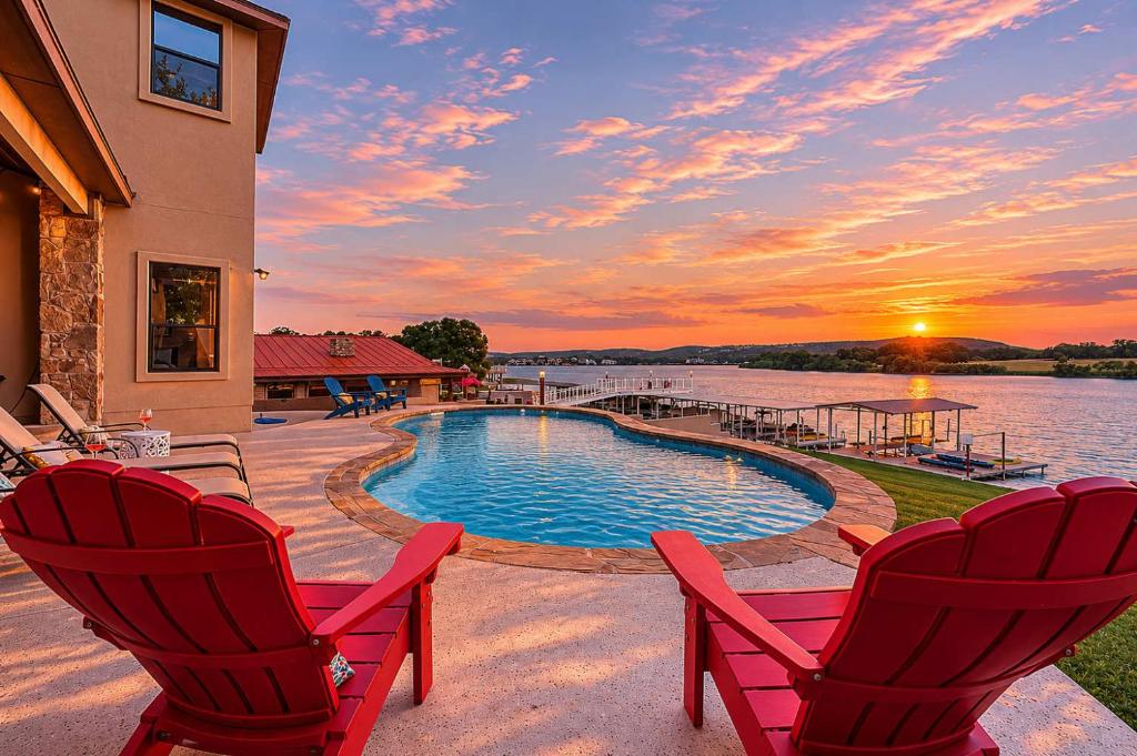 a patio with two chairs and a swimming pool at 119 Christopher Concierge Services Available in Kingsland