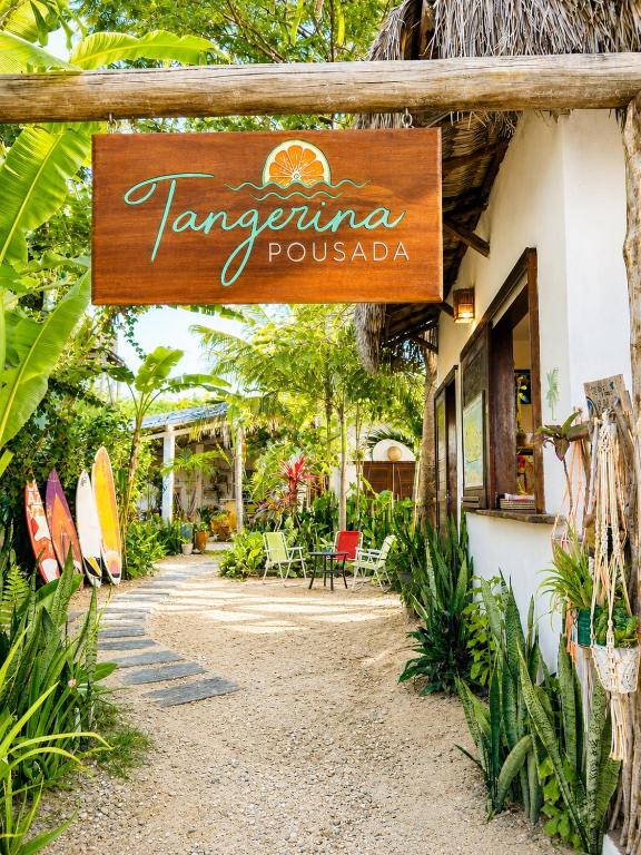 a restaurant with a sign that reads karma pousada at Pousada Tangerina in Icaraí