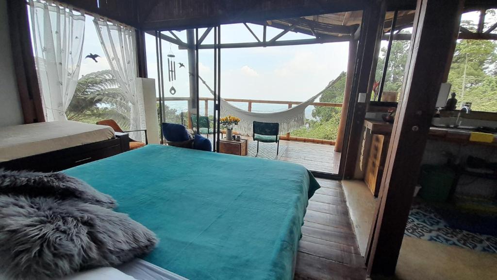 a bedroom with a bed and a large window at Lunanueva in Cali