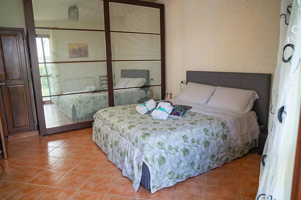 a bedroom with a bed and a large mirror at Via della Musica in Vicchio
