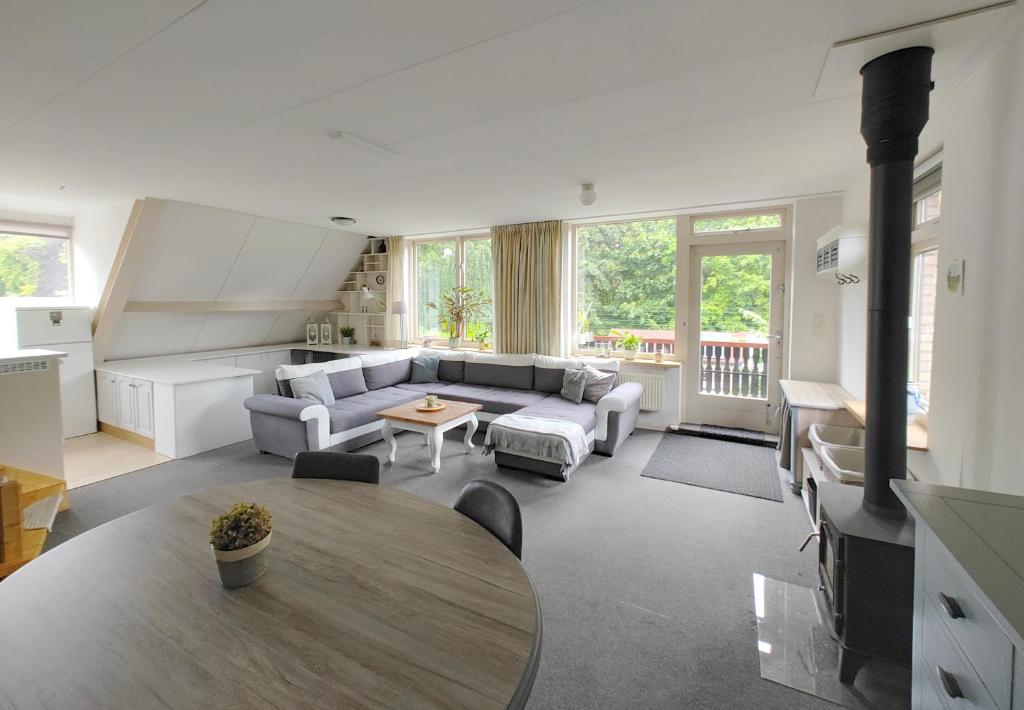 a living room with a table and a couch at VolopVeluwe in Ermelo