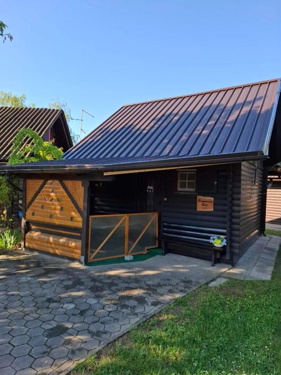 a house with a metal roof and a garage at Brunarica Beti in Brežice
