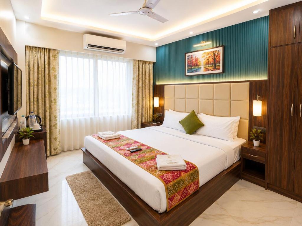 a hotel room with a bed and a television at Hotel Royale Elite RK Residency in Vrindāvan