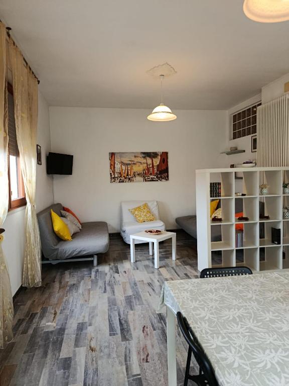 a living room with a couch and a table at Appartamenti Sole&Mare in Marotta