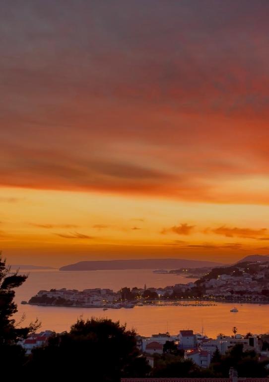 a sunset view of a city and a body of water at Bellavista in Strožanac