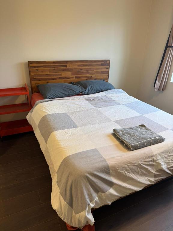 a bed with a blue and white blanket on it at Large Private Room Near Meta & Tech Hubs in Menlo Park