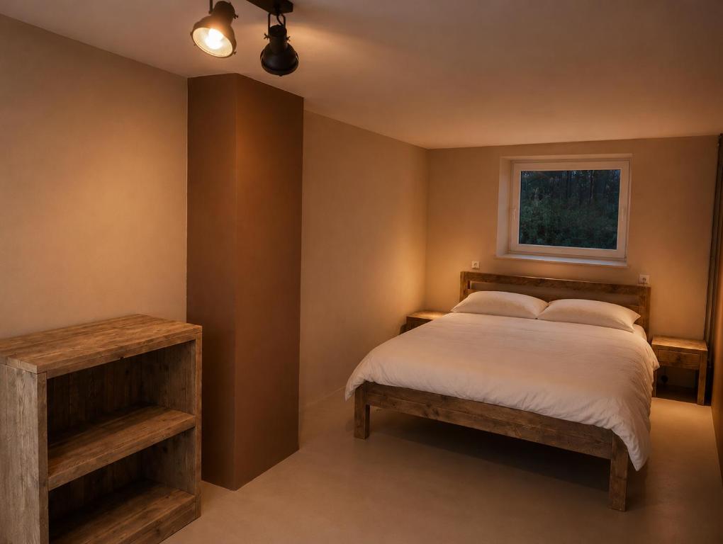 a bedroom with a bed and a window at Appartement voor Gezin Ardennen The Moon Valley in Amblève