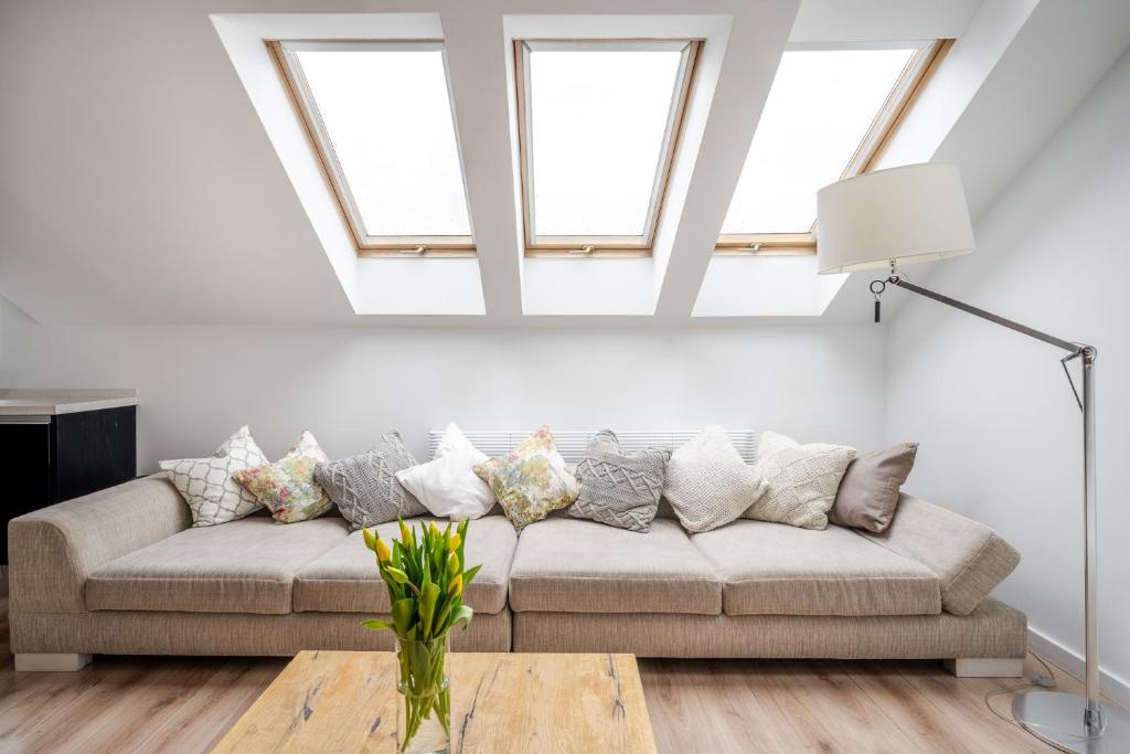 a living room with a couch and a table at Kopernik Loft Jelenia Góra in Jelenia Góra