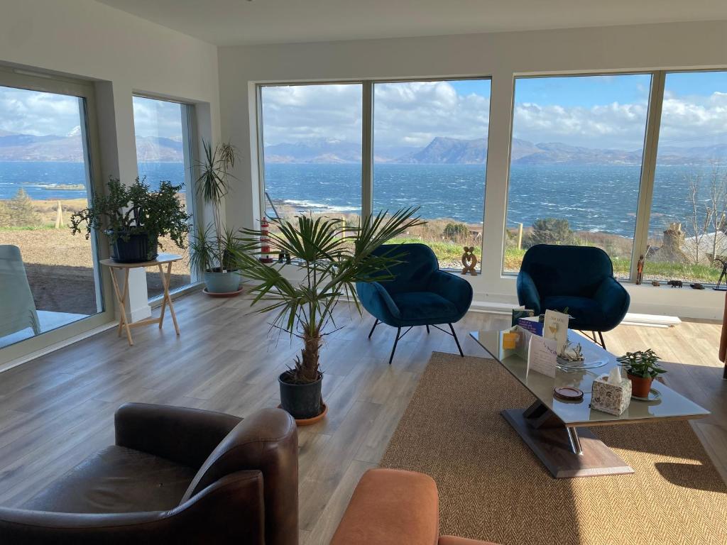 a living room with a view of the ocean at Skyelyne in Ardvasar