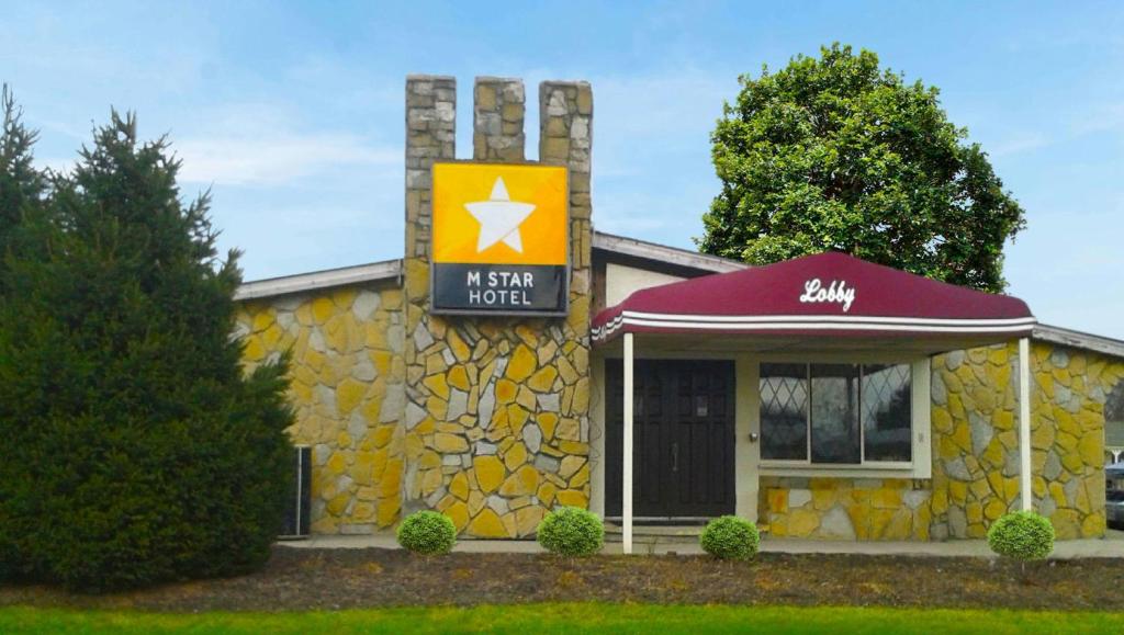 a k star hotel sign in front of a building at M Star Columbus North in Worthington