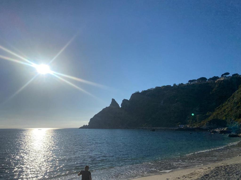 a man standing on a beach near the water at HolidayHomePalma in Santa Maria