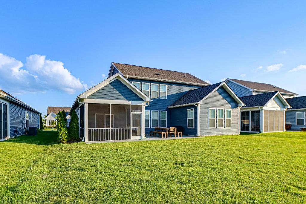 a row of houses with a grass yard at Beach Shuttle! Spacious Bishop’s Landing Retreat in Ocean View