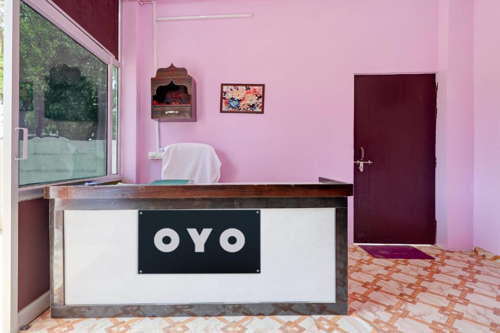 a reception desk in a pink room with an open door at SPOT ON S.S HOTEL in Lucknow