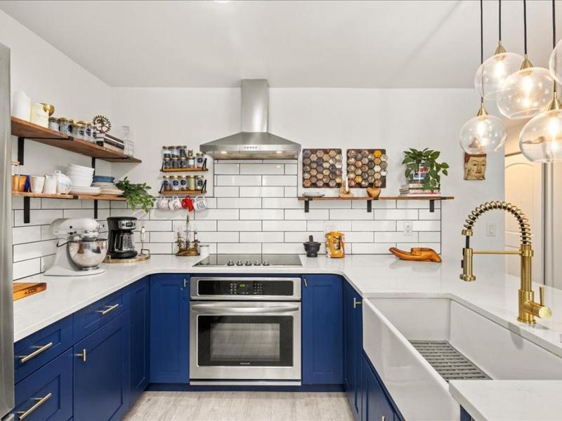 a kitchen with blue cabinets and a sink at G125 by SkyRun Aspen in Snowmass Village