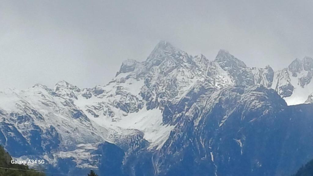 a large snow covered mountain range with snow at Sunhill Apartamente in Karrösten