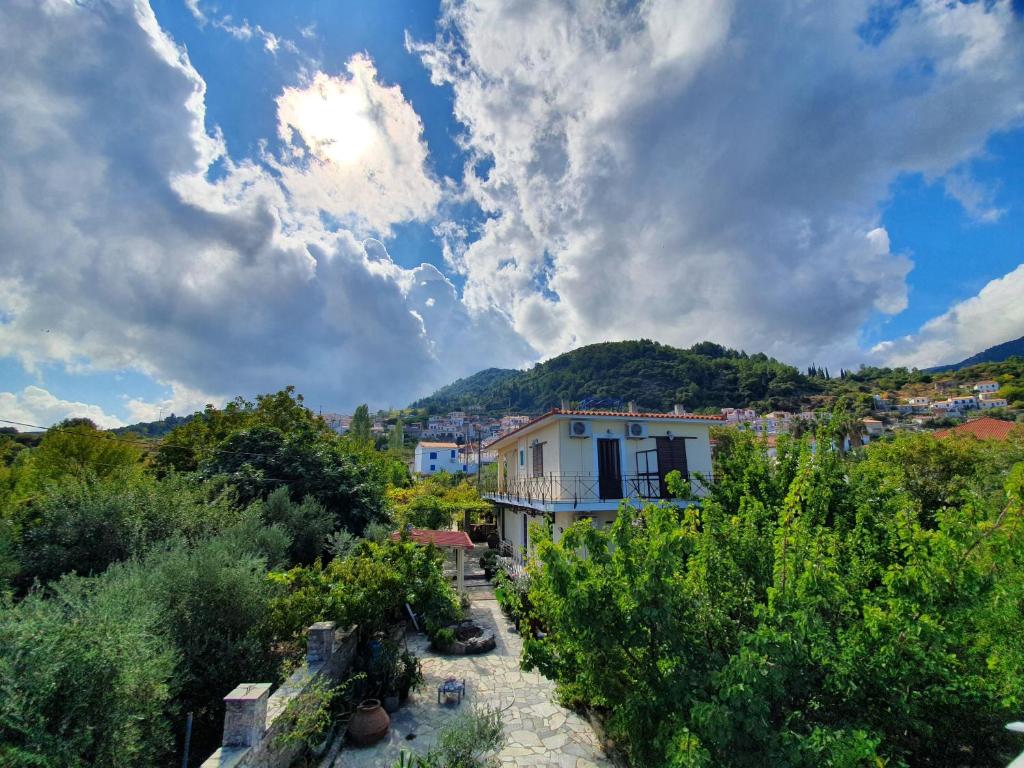 a view of a town with a building and trees at Mary's House in Vourliótai