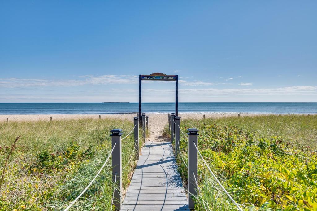 a wooden path to the beach with a sign on it at Old Orchard Beach Condo: Steps From the Beach! in Old Orchard Beach