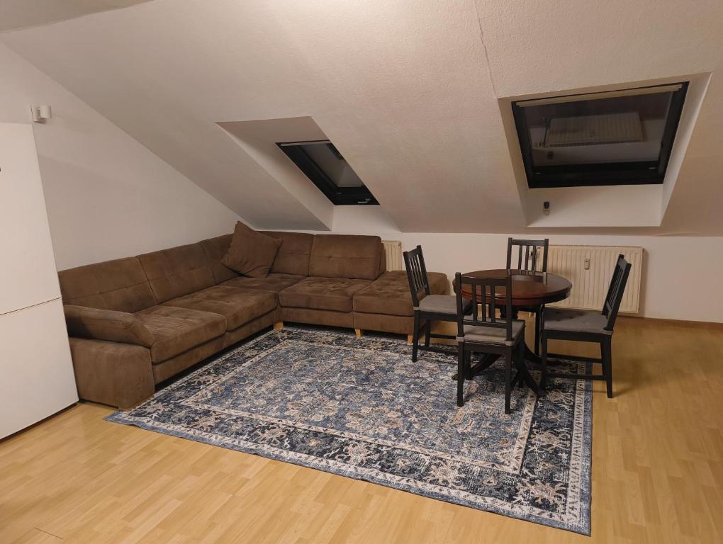 a living room with a couch and a table at Apartment in Bergheim