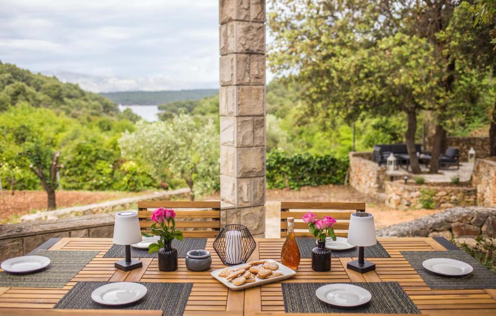 a wooden table with a plate of food on it at Kuća za odmor Olea in Stari Grad