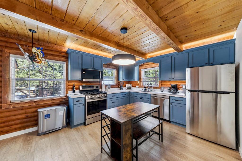 a kitchen with blue cabinets and a wooden ceiling at Twin Peaks Cabin in South Lake Tahoe