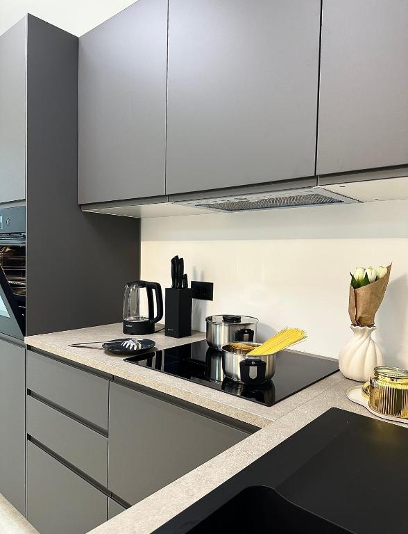 a kitchen with white cabinets and a stove top oven at APP Steps to the Sea 2026 in Funtana