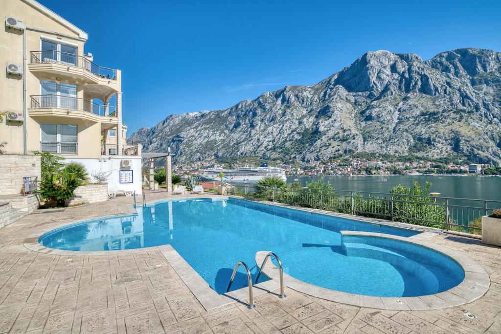 a swimming pool with a view of a mountain at Apartments Vista Muo 2026 NEWLY RENOVATED in Kotor