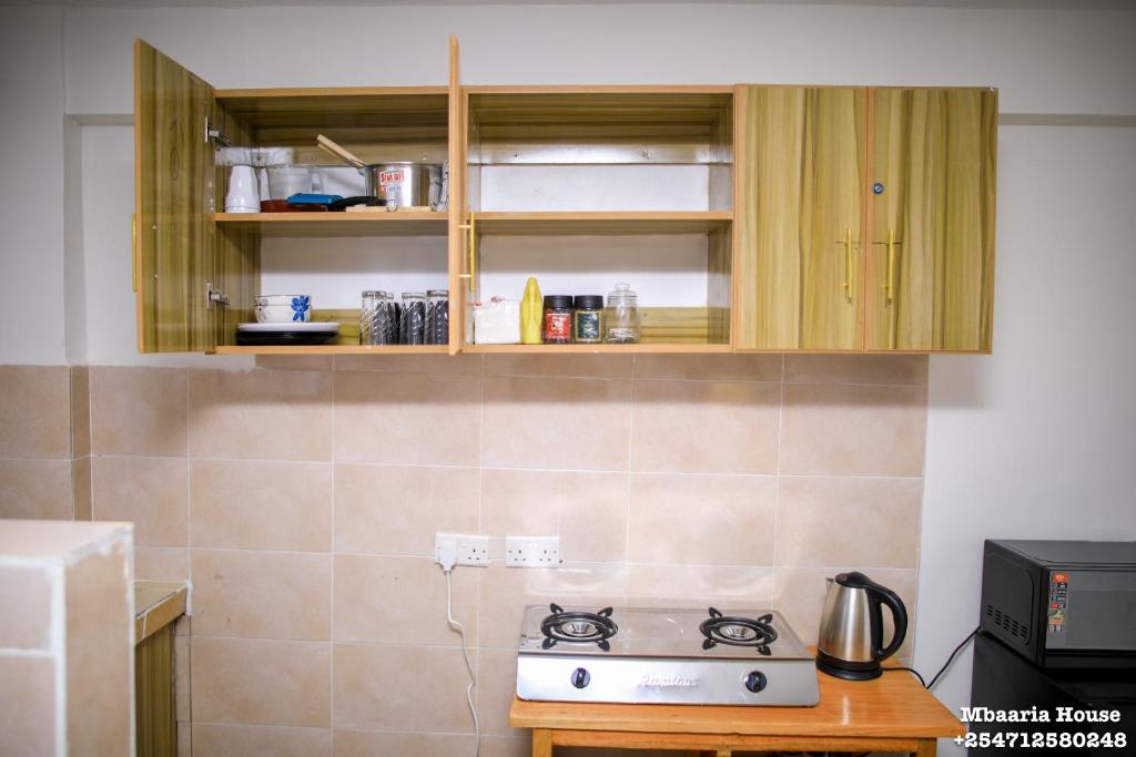 a kitchen with a stove top in a kitchen at Mbaaria House, Meru in Meru