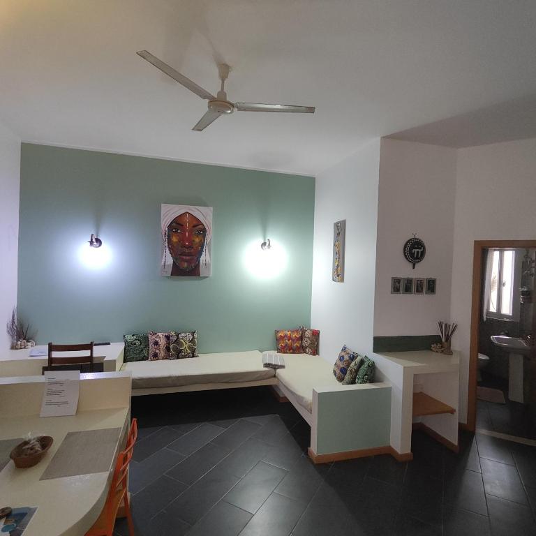 a living room with a couch and a ceiling fan at Casa Papaya19 in Sal Rei