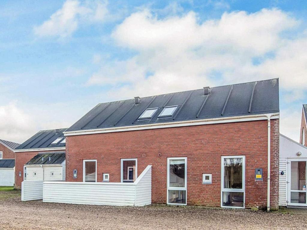 a red brick building with solar panels on it at 6 person holiday home in Rømø-By Traum in Sønderby