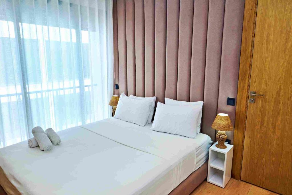 a bedroom with a bed and a large window at Prestige studio in Maarif