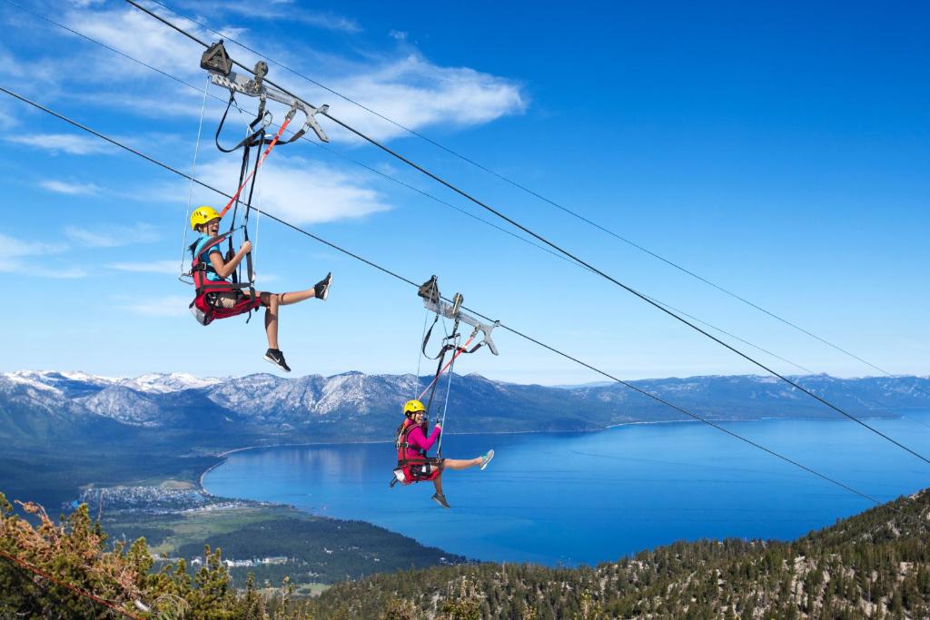 two people on a zip line over a lake at Tahoe Keys #214 in South Lake Tahoe