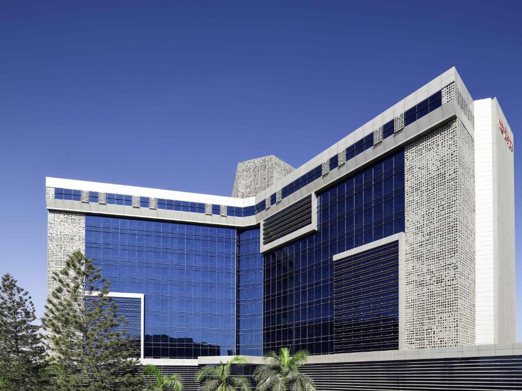a large office building with a lot of windows at Mövenpick Hotel Karachi in Karachi