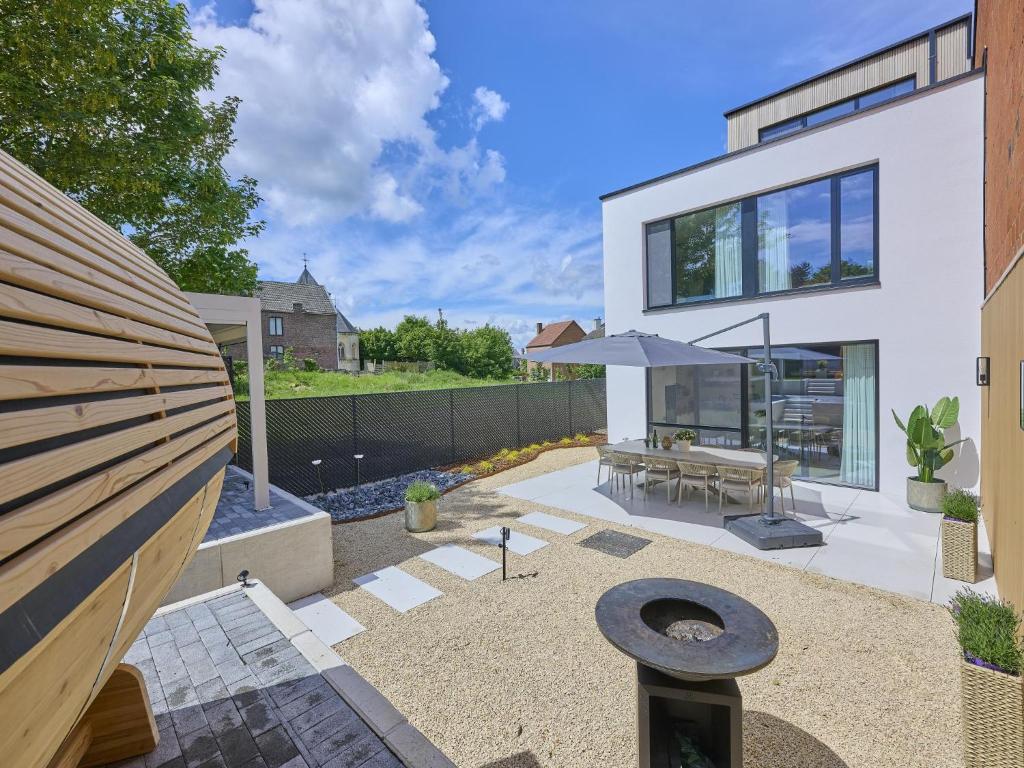 a backyard with a table and an umbrella at t Margrietje in Riemst