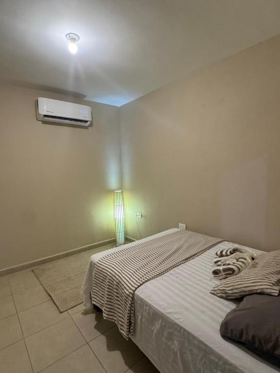 a bedroom with a bed and a heater on the wall at Departamento #10 in San Carlos