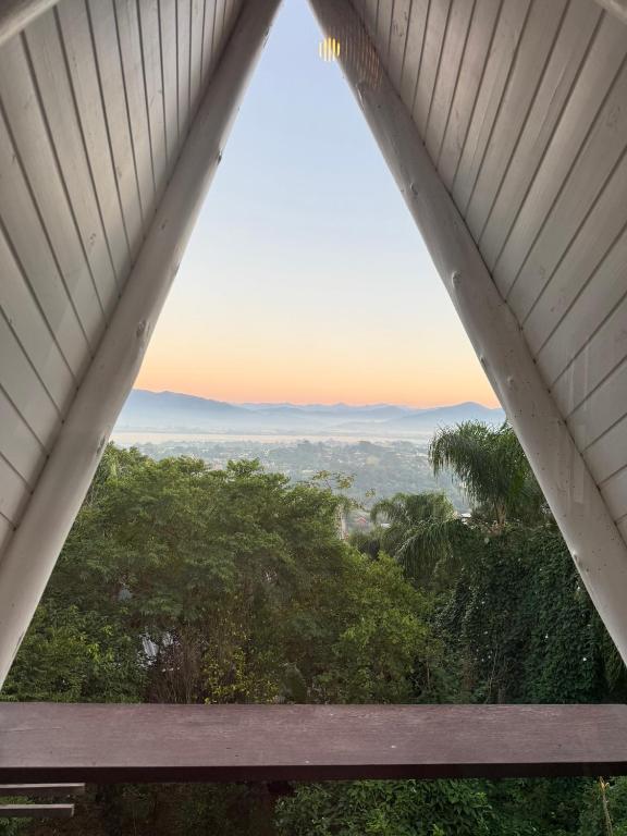 a view from the roof of a house with a window at Chalé cercado pela natureza in Imbituba