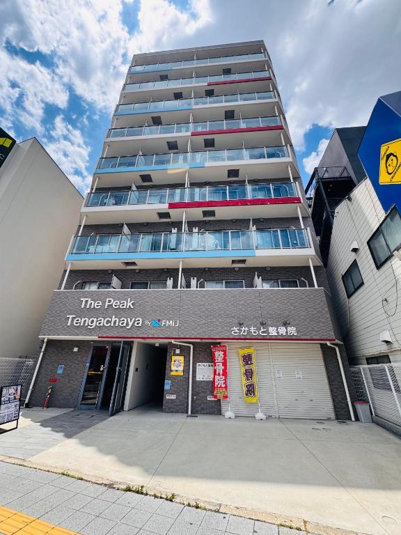a tall apartment building with a sign on it at u-heim Osaka Tengachaya in Osaka