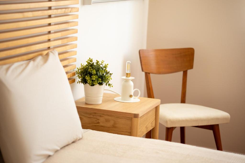 a bedroom with a bed with a table and a chair at BE LOST - Guest House in Pedra Do Ouro