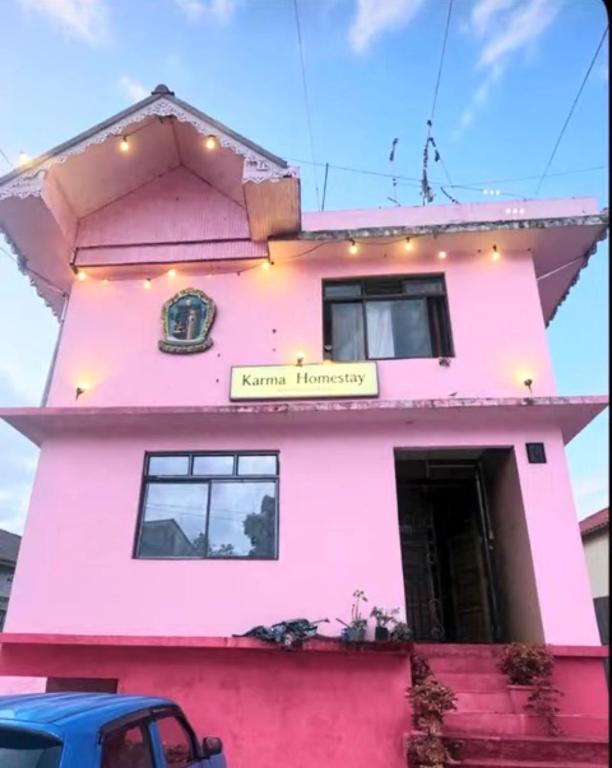 a pink house with a sign on it at Karma homestay in Ravangla