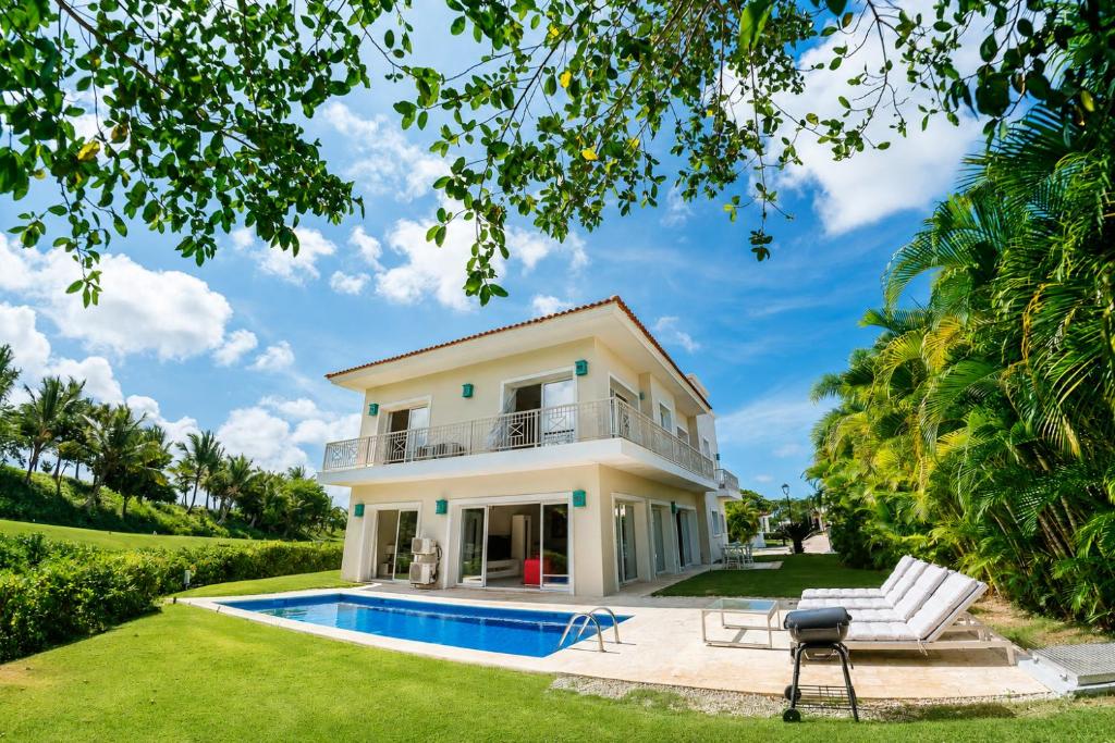 a villa with a swimming pool and a house at Private Iberosta Villa Lagoon 4BDR- Private Beach and Pool in Punta Cana