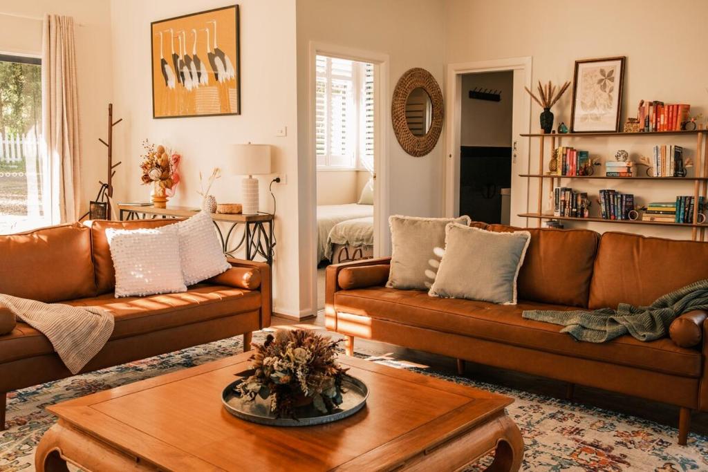 a living room with leather couches and a coffee table at VeraLuna in Garden Island Creek