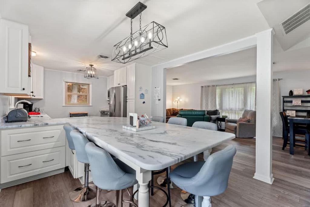 a kitchen and living room with a large table and chairs at Arden Place - Spacious Retreat with Pool in High Point