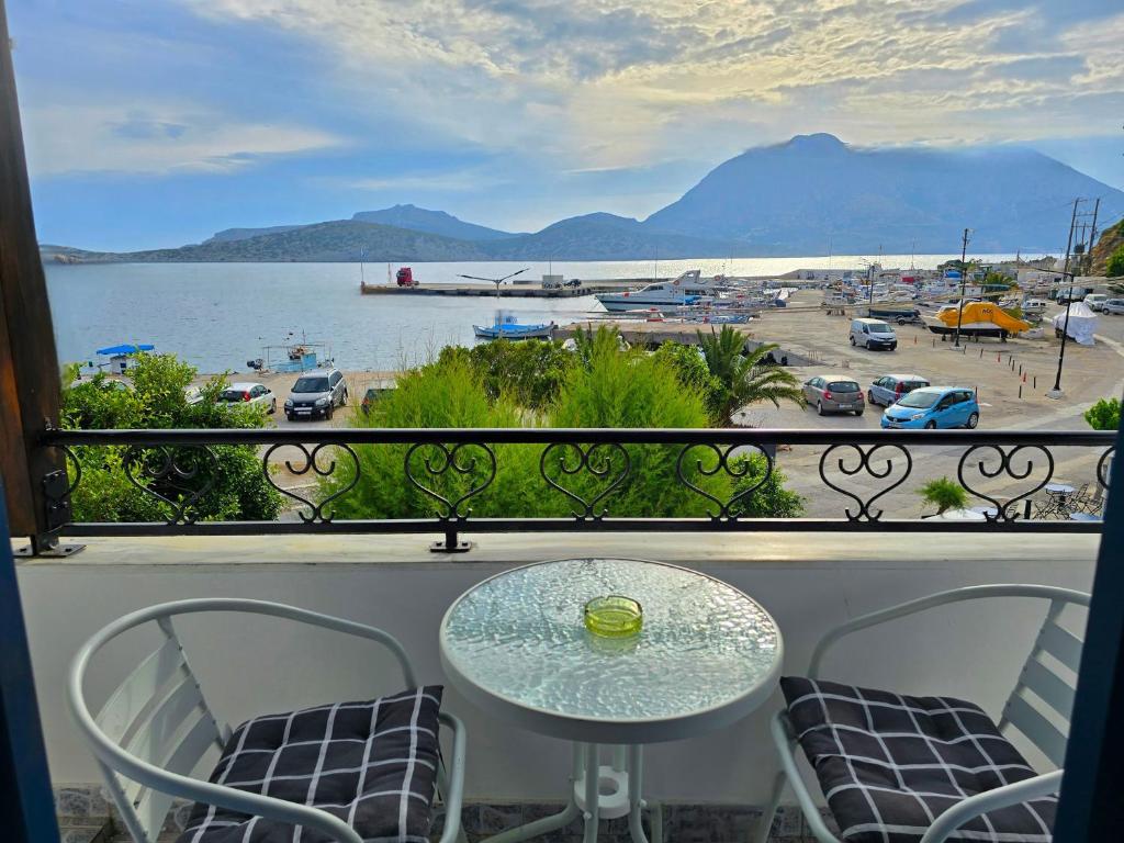 a table on a balcony with a view of the water at Agla Studio 2 in Fournoi