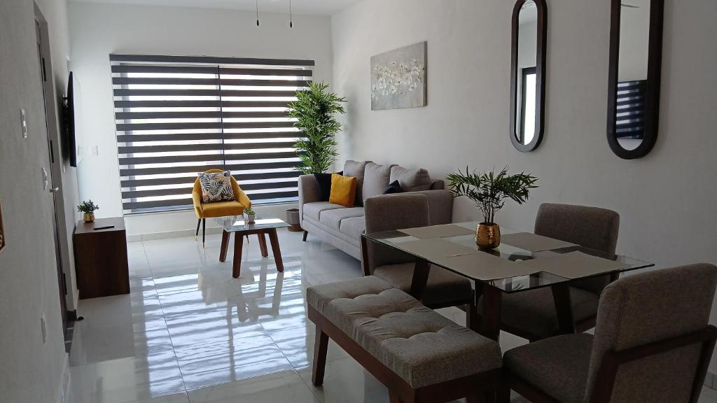 a living room with a couch and a table at Orion 2nd Floor in Tepic